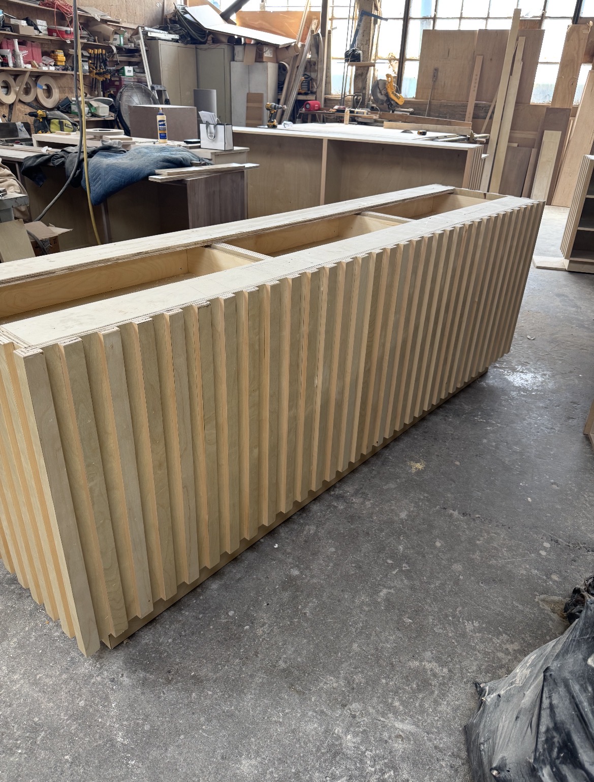 Custom fluted retail casework in fabrication